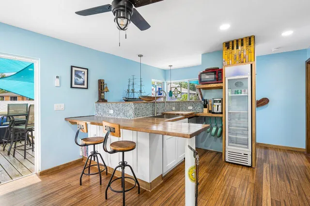 a kitchen with stainless steel appliances granite countertop a sink and a refrigerator