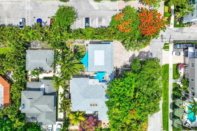 an aerial view of a house with a yard and garden