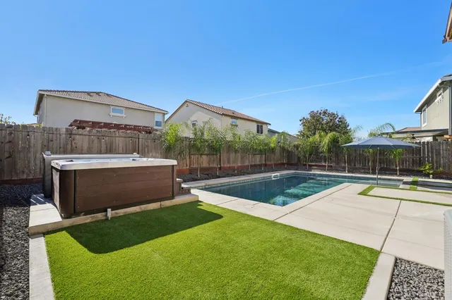 a view of a house with backyard sitting area and garden