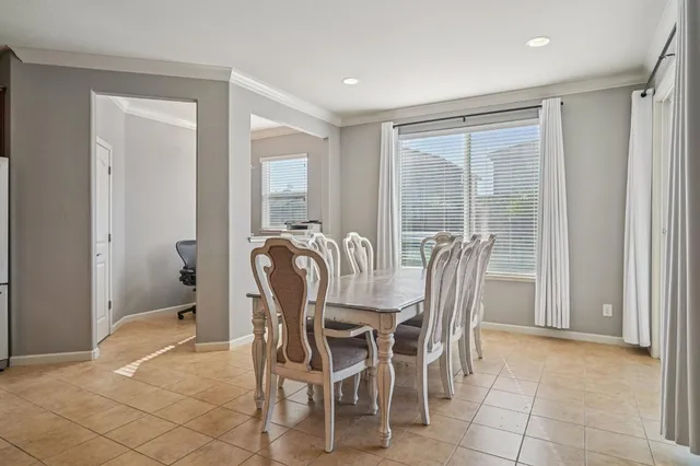 a dining room with furniture and window