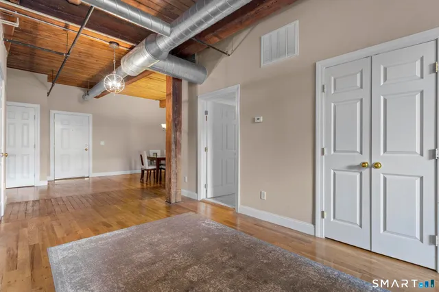 a view of a hallway with wooden floor