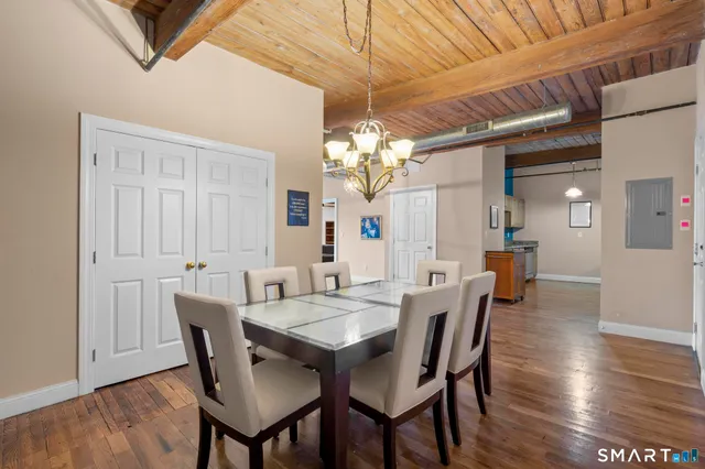 a view of a dining room with furniture and wooden floor