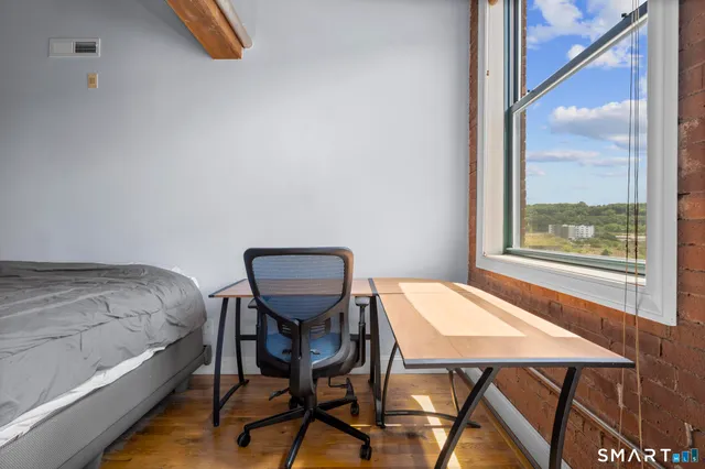 a view of a dining room with furniture and a window