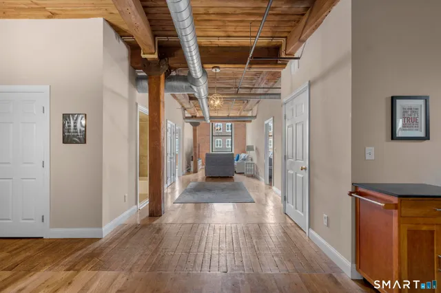 a view of hallway with wooden floor