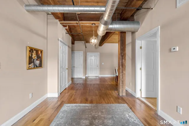 a view of hallway with wooden floor
