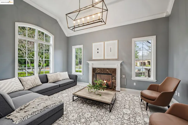 a backyard of a house with fountain table and chairs