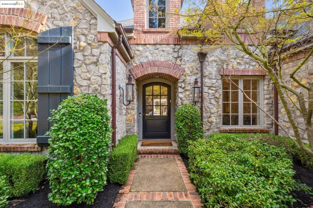 a kitchen with stainless steel appliances kitchen island granite countertop a sink stove and refrigerator