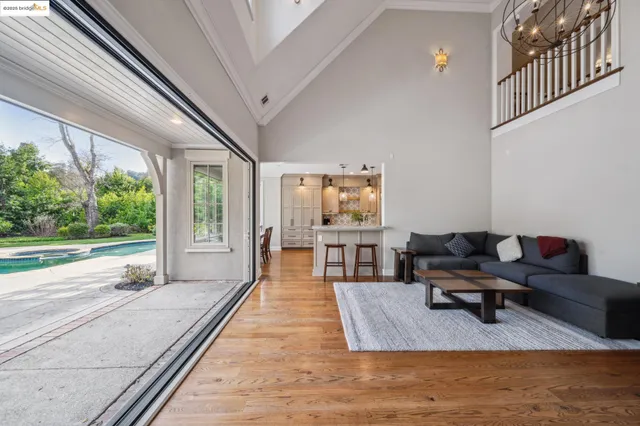 a kitchen with sink and view of living room