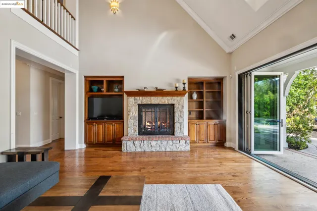 a view of a patio with table and chairs potted plants and large tree
