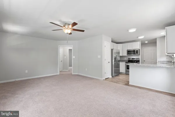 a kitchen with granite countertop stainless steel appliances and a sink