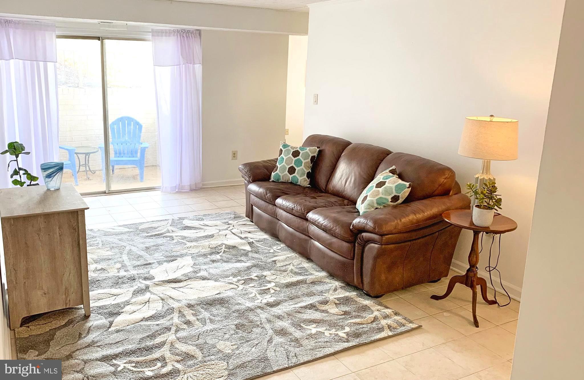 8011 Mandan Road, Unit 503 Greenbelt, MD 20770 - Photo 3 of 25 Nice Sized Living Room with Sliders to Patio