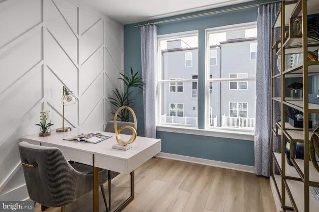 a view of a workspace with furniture and a window