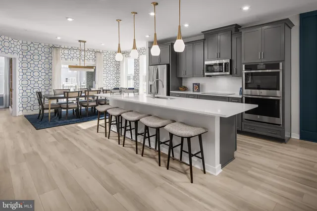 a large kitchen with a table and chairs