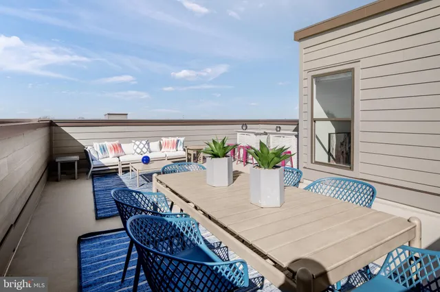 a outdoor dining space with furniture and wooden floor