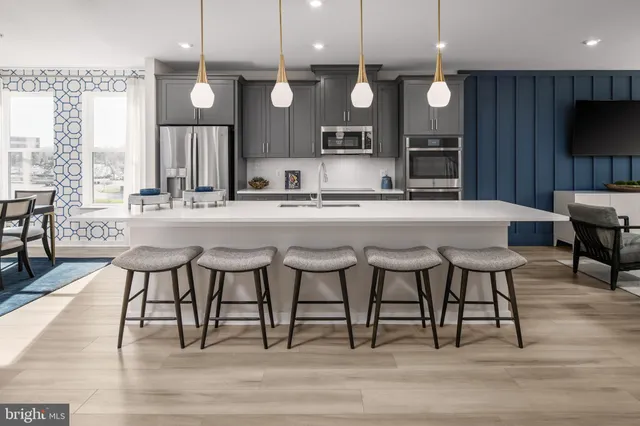 a large kitchen with a table and chairs