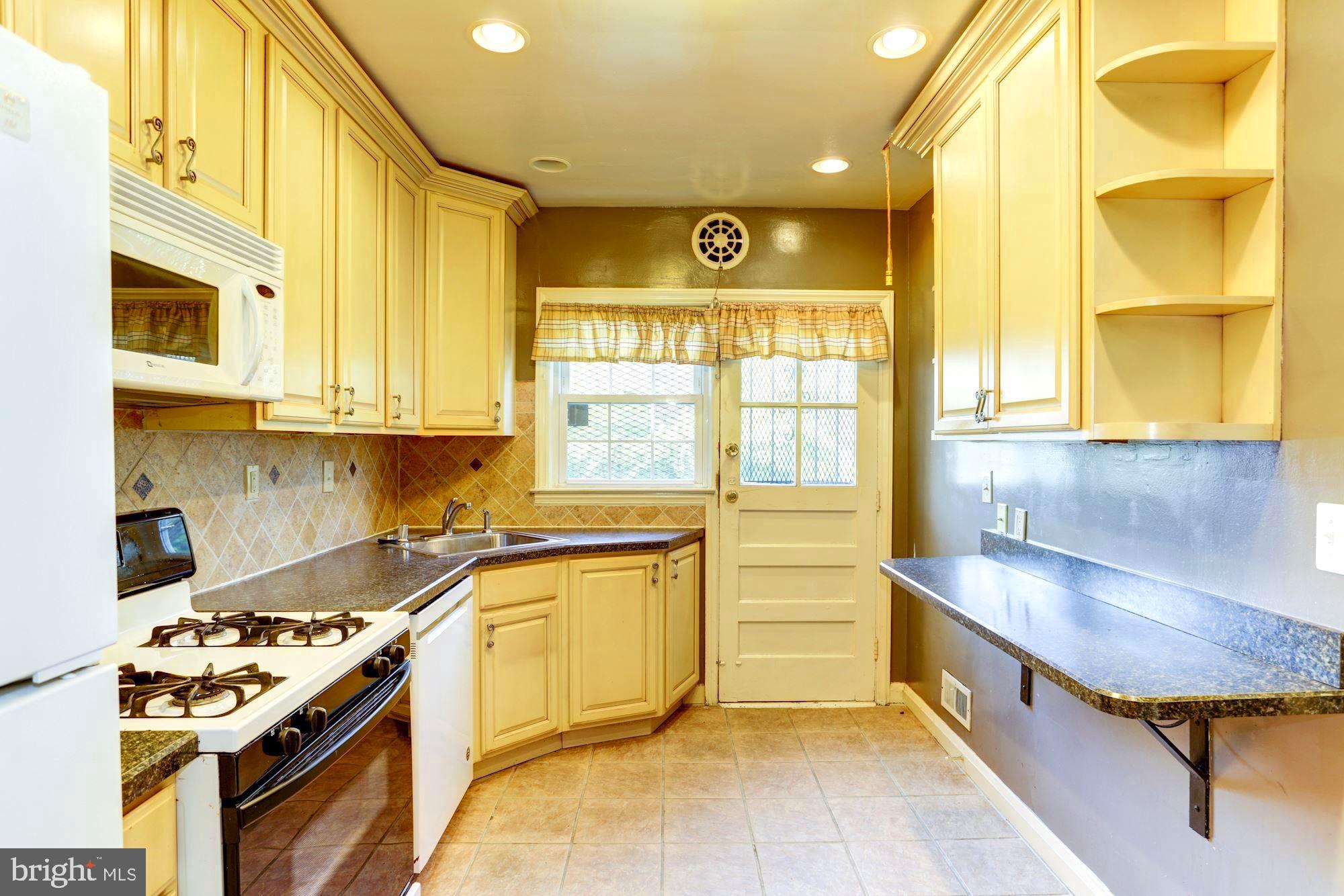3602 Delverne Road Baltimore, MD 21218 - Photo 11 of 28 a kitchen with stainless steel appliances granite countertop a stove a sink and a microwave