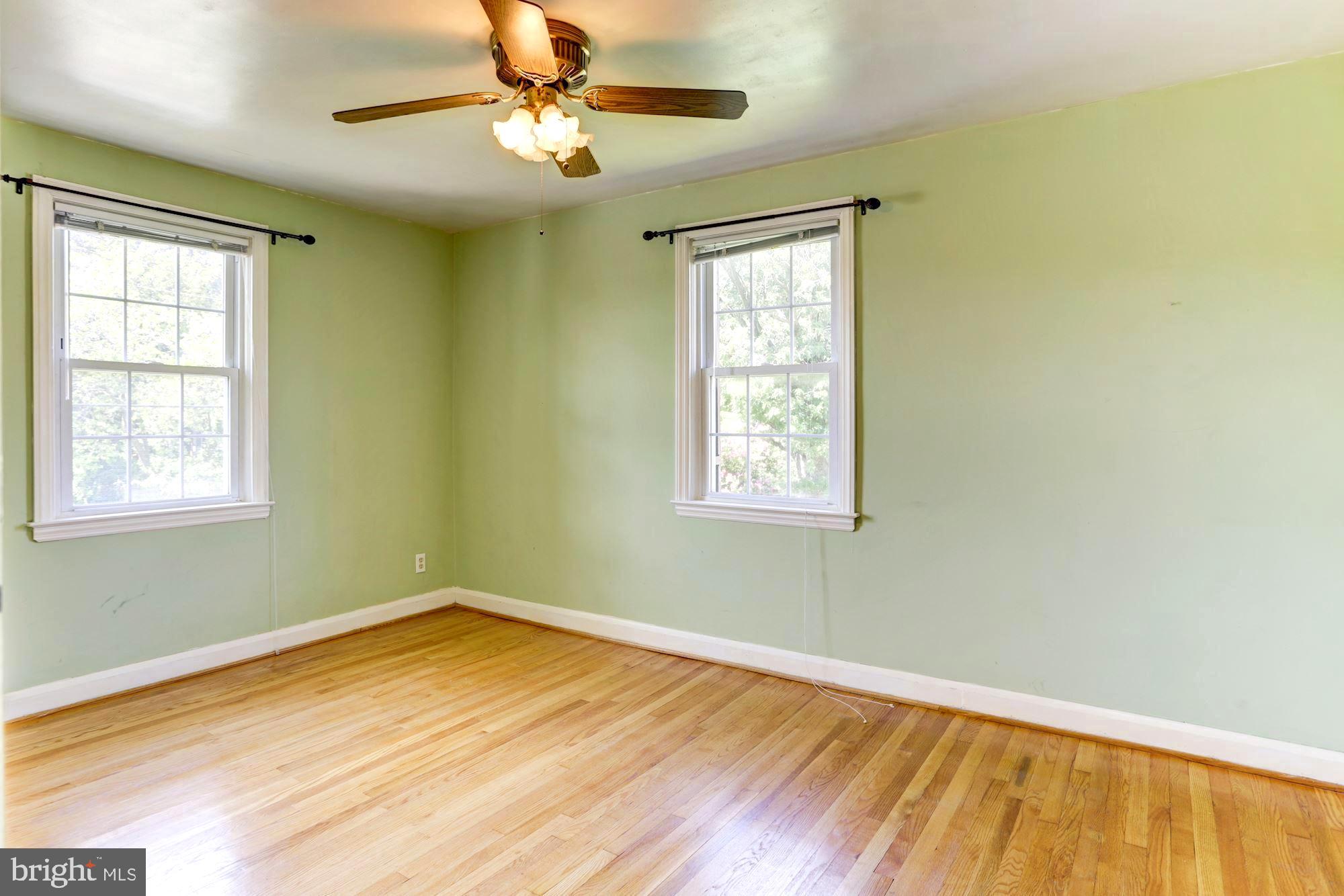 3602 Delverne Road Baltimore, MD 21218 - Photo 15 of 28 a view of empty room with wooden floor and fan