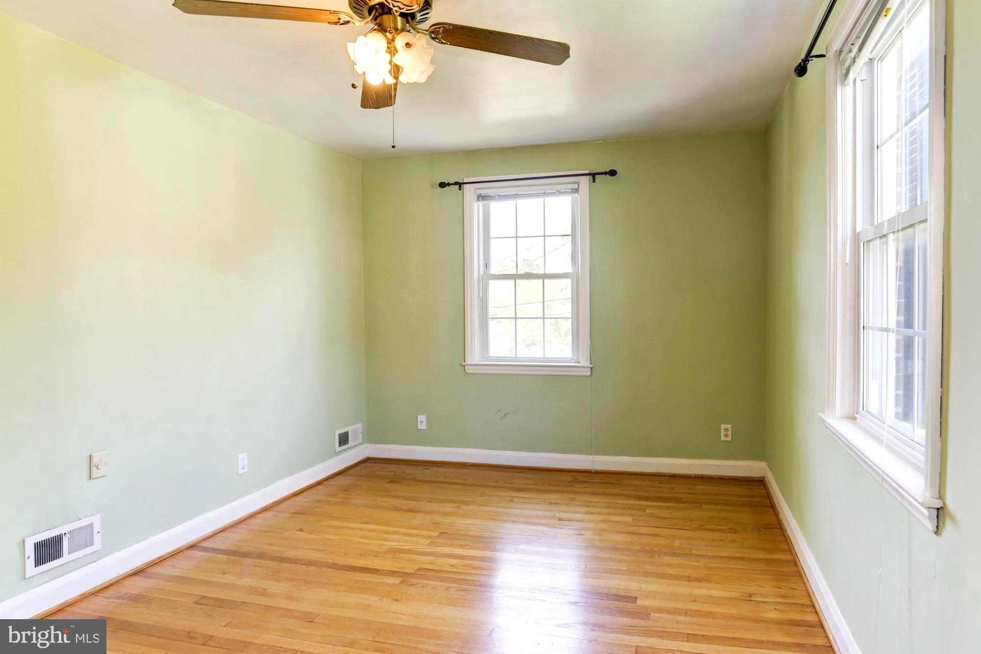 3602 Delverne Road Baltimore, MD 21218 - Photo 16 of 28 wooden floor in an empty room with a window