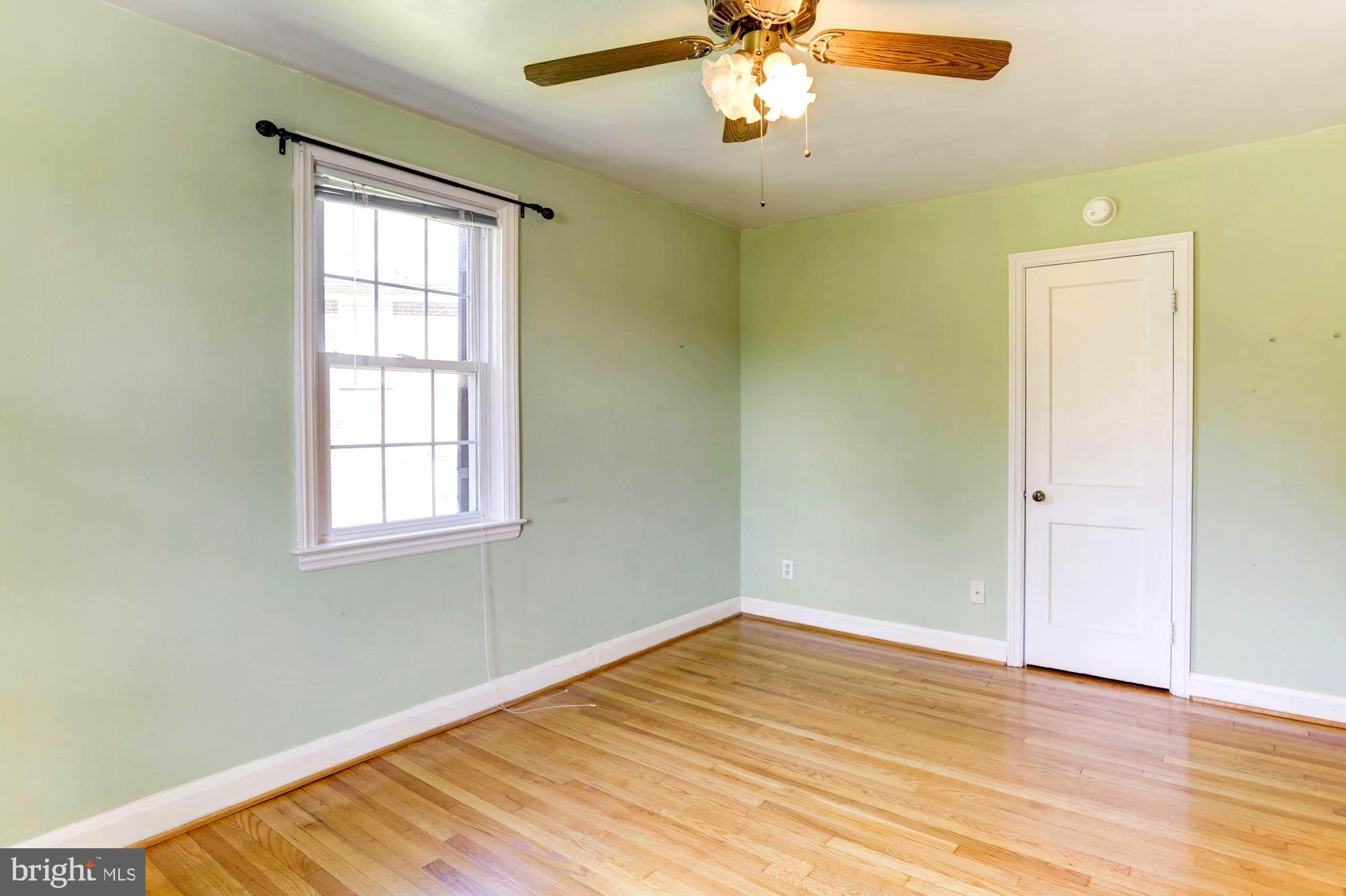 3602 Delverne Road Baltimore, MD 21218 - Photo 17 of 28 wooden floor in an empty room with a window