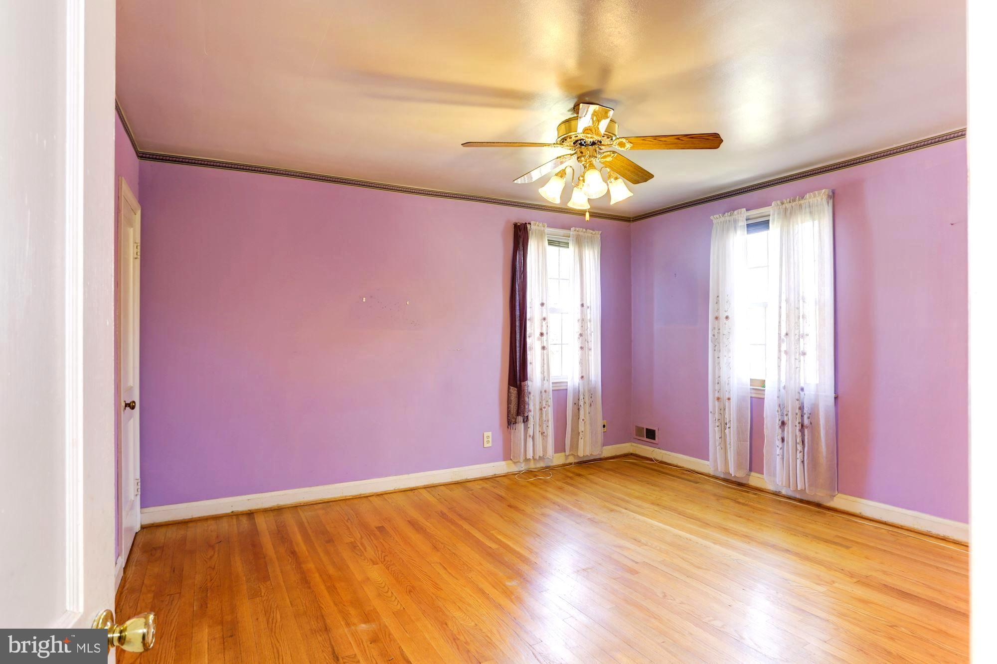 3602 Delverne Road Baltimore, MD 21218 - Photo 18 of 28 a view of an empty room with window and chandelier fan