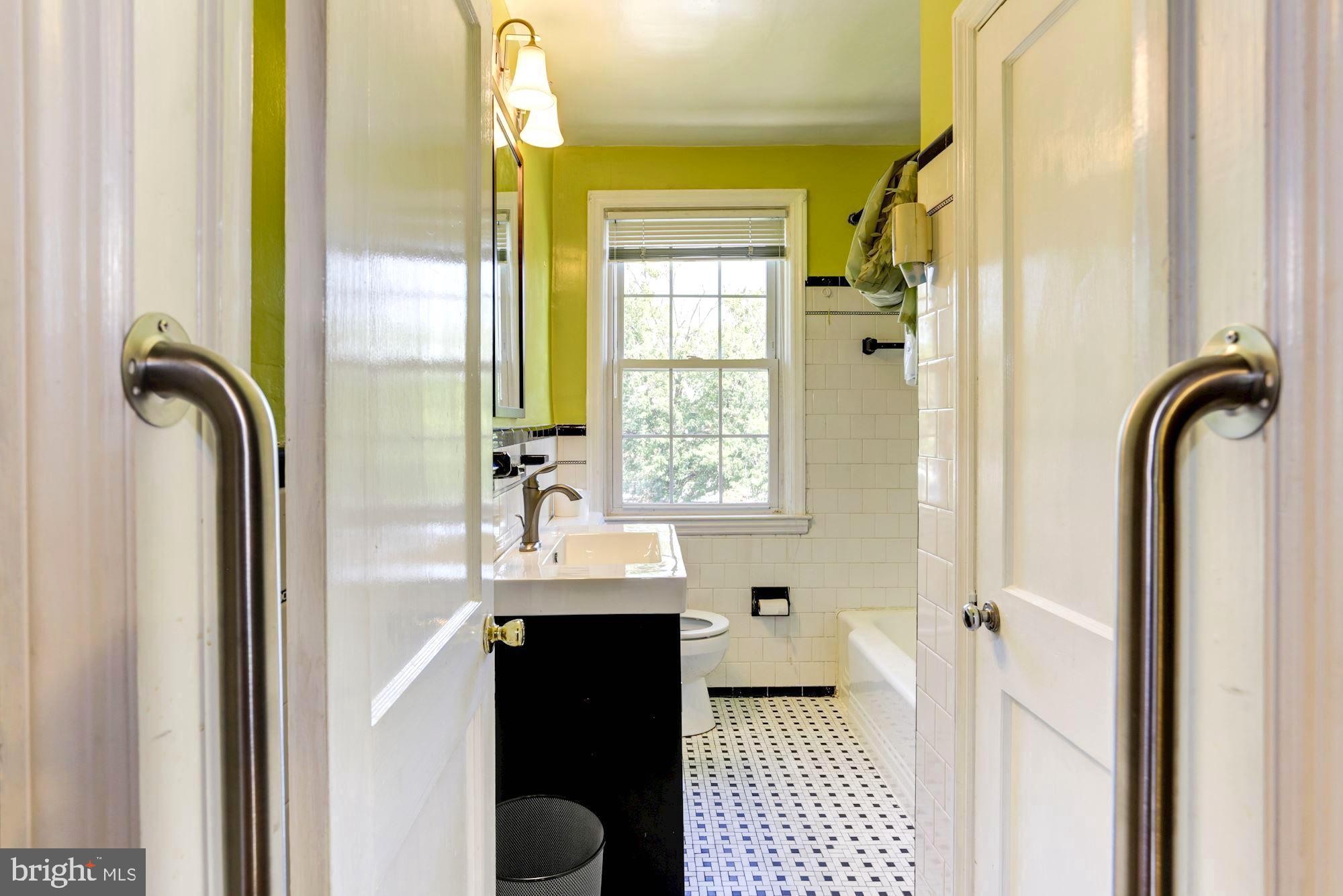 3602 Delverne Road Baltimore, MD 21218 - Photo 21 of 28 a bathroom with a sink a mirror and a shower