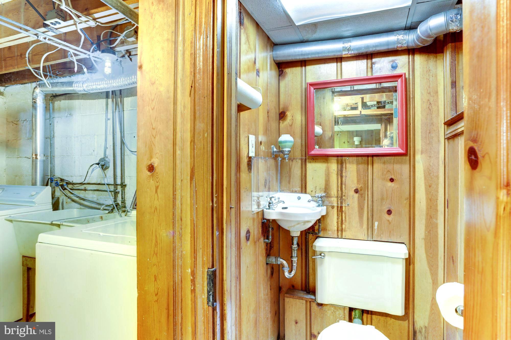 3602 Delverne Road Baltimore, MD 21218 - Photo 25 of 28 a bathroom with a granite countertop sink and a mirror
