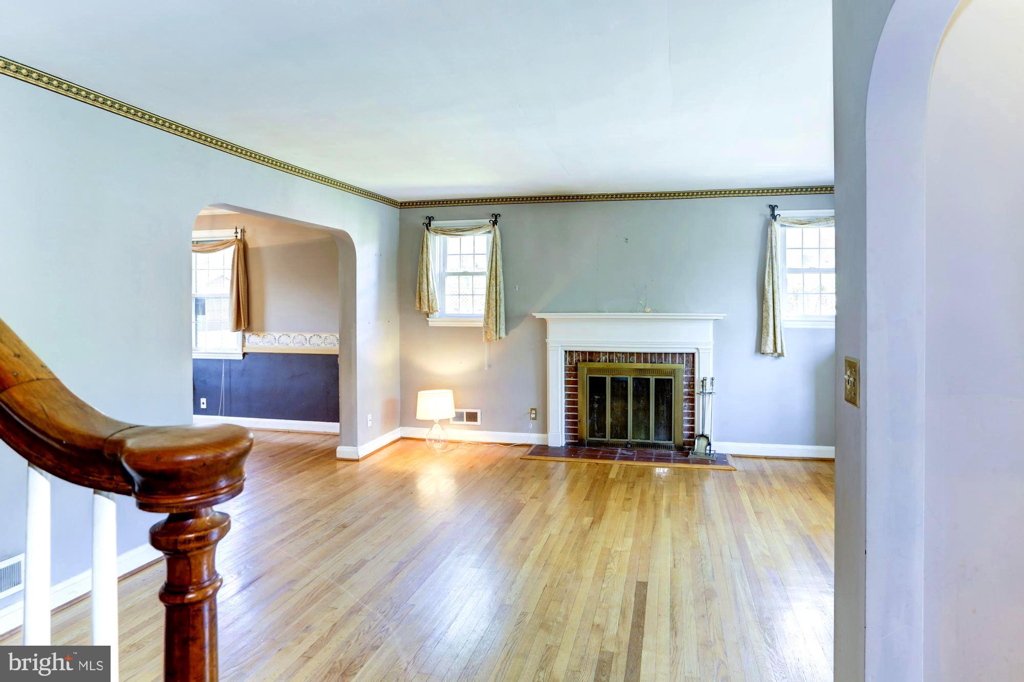 3602 Delverne Road Baltimore, MD 21218 - Photo 6 of 28 a view of a livingroom with a fireplace and window