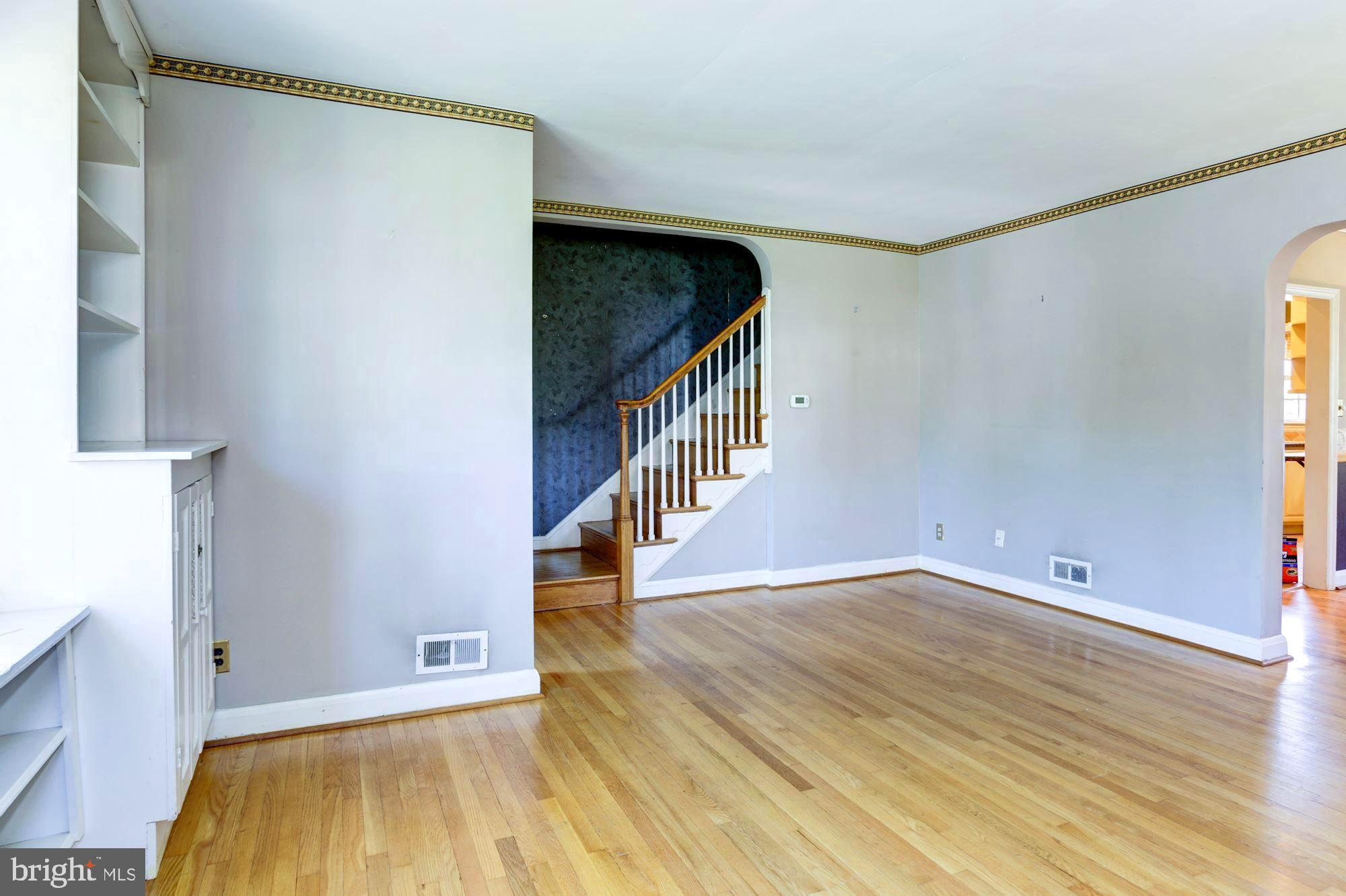 3602 Delverne Road Baltimore, MD 21218 - Photo 7 of 28 a view of an empty room with wooden floor and a window
