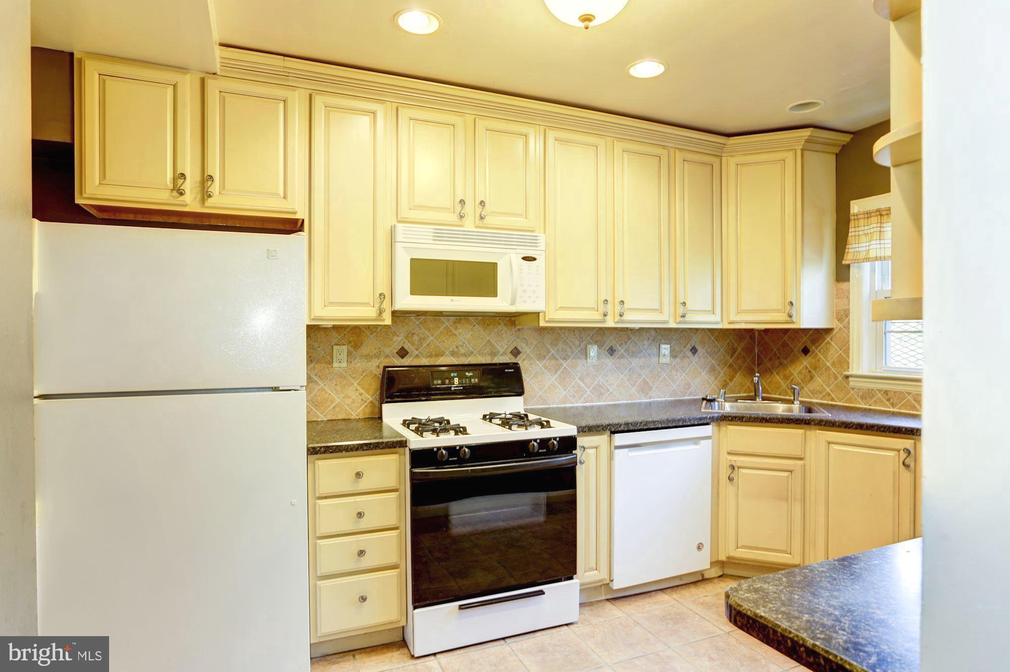 3602 Delverne Road Baltimore, MD 21218 - Photo 10 of 28 a kitchen with stainless steel appliances a refrigerator sink and cabinets