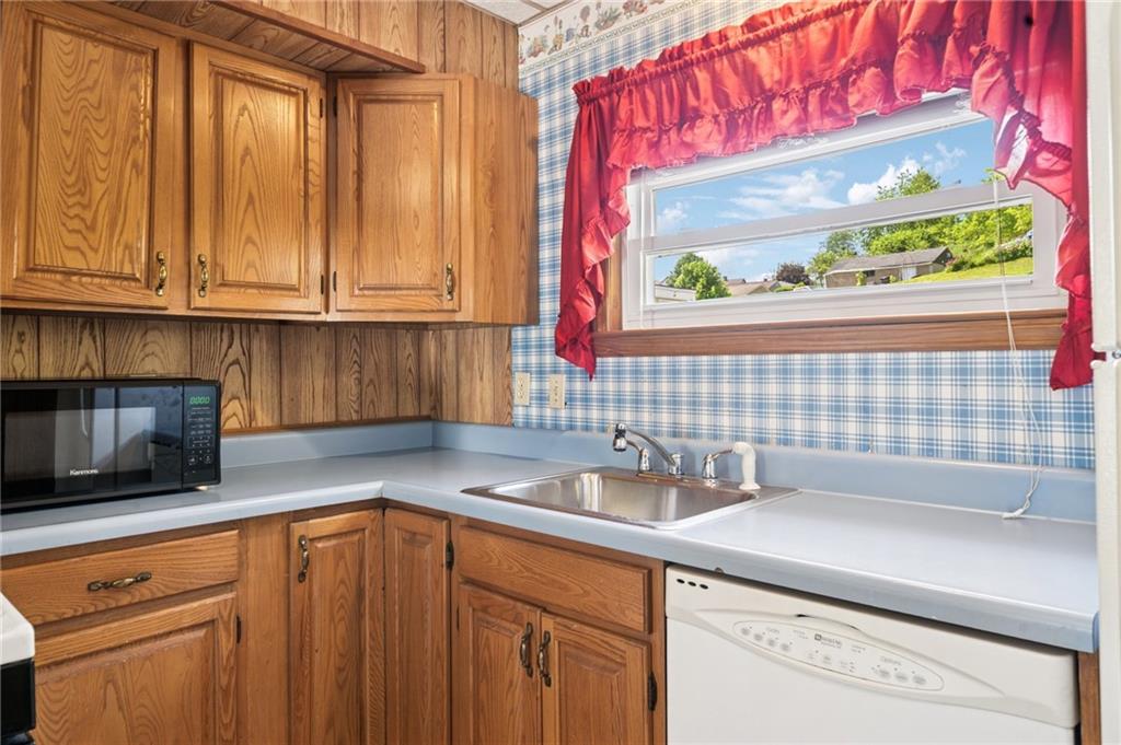 600 Scott Street Penn, PA 15675 - Photo 12 of 33 a kitchen with stainless steel appliances wooden cabinets a sink and a window