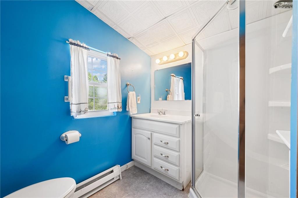600 Scott Street Penn, PA 15675 - Photo 17 of 33 a bathroom with a toilet sink a mirror and window