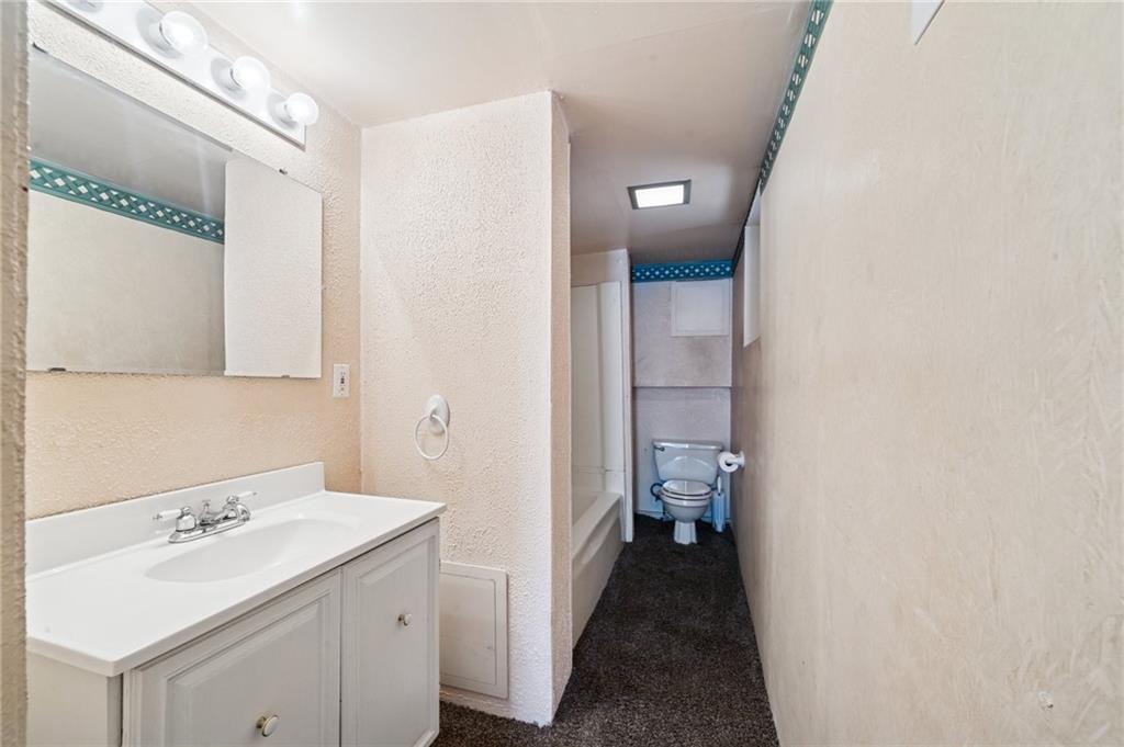 600 Scott Street Penn, PA 15675 - Photo 22 of 33 a bathroom with a sink a toilet and a mirror