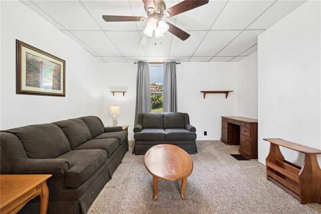 600 Scott Street Penn, PA 15675 - Photo 6 of 33 a living room with furniture a flat screen tv and a fireplace