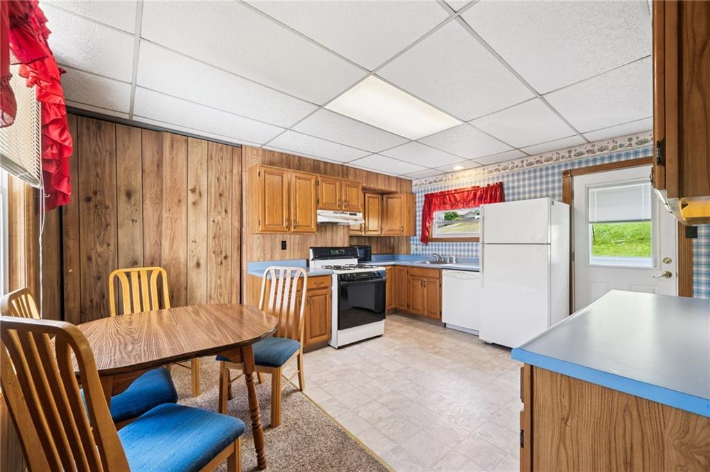 600 Scott Street Penn, PA 15675 - Photo 8 of 33 a kitchen with a dining table chairs and refrigerator