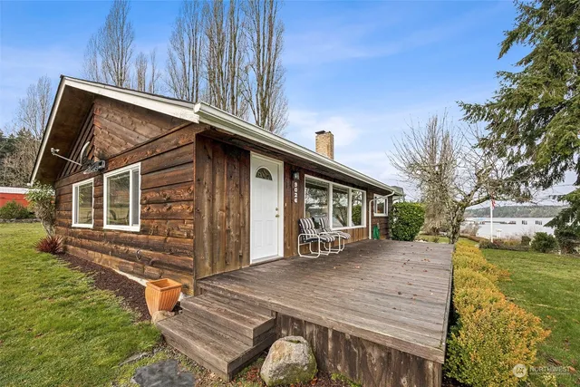 a yellow house sitting in middle of the middle of a field