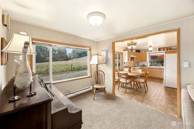 a kitchen with a sink window and white cabinets