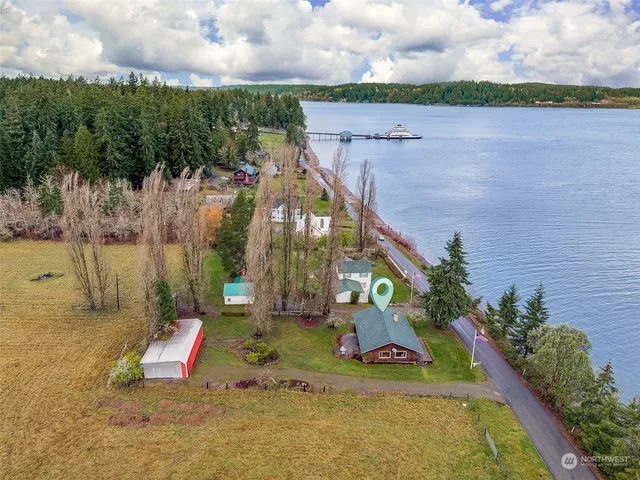 an aerial view of a house with a garden and lake view