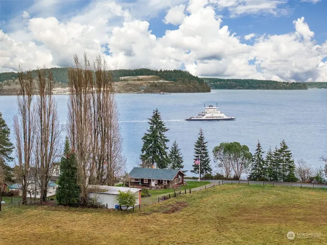 a view of a big house with a big yard and potted plants