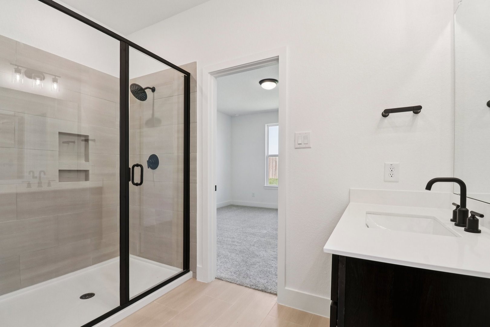 14470 Trumpet Lane Splendora, TX 77372 - Photo 11 of 27 a bathroom with a shower sink and mirror
