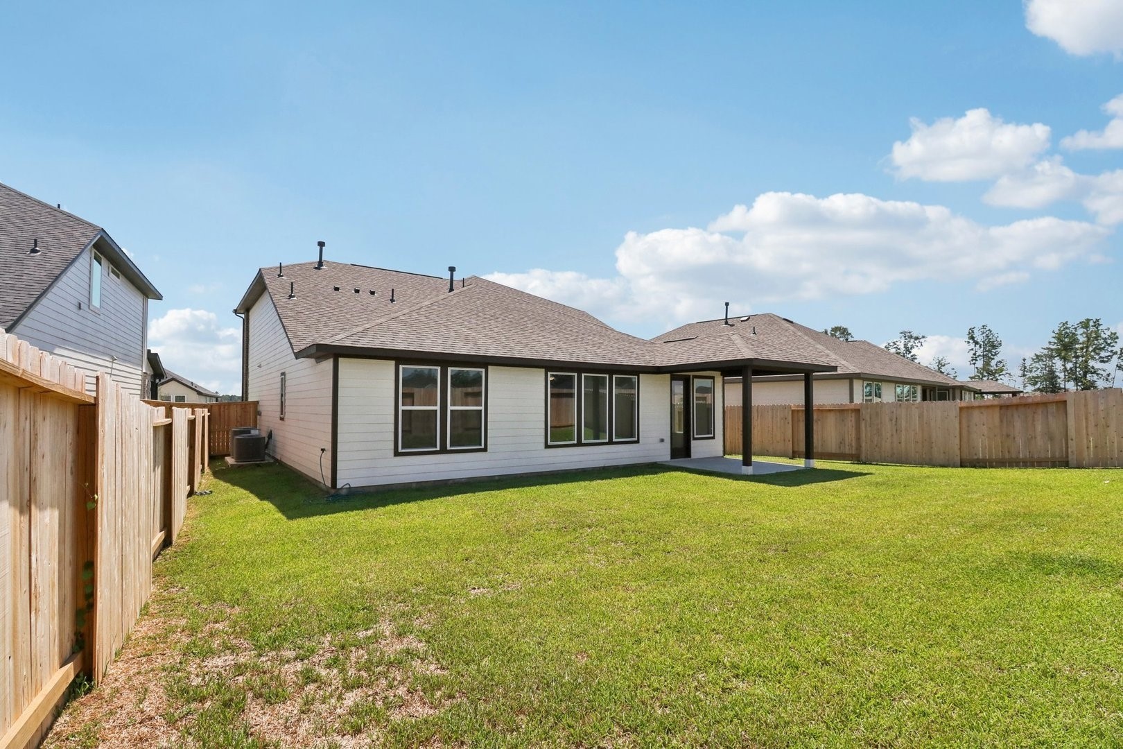 14470 Trumpet Lane Splendora, TX 77372 - Photo 22 of 27 a view of a house with a yard and a large tree