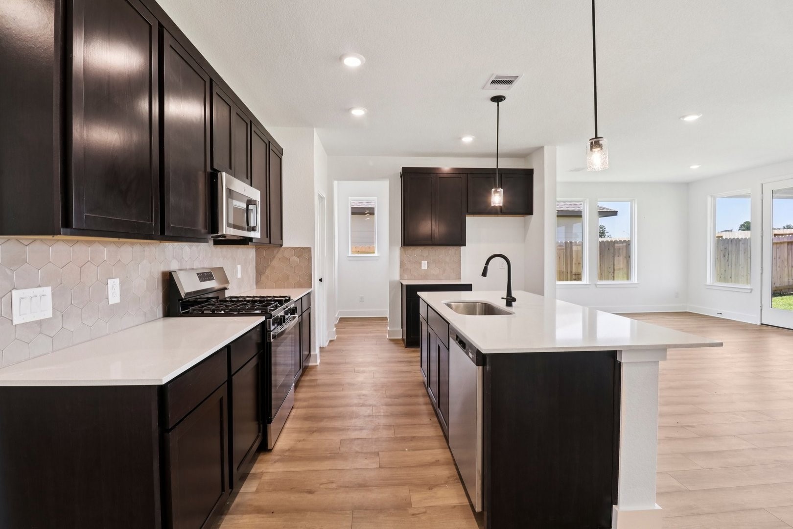 14470 Trumpet Lane Splendora, TX 77372 - Photo 5 of 27 a kitchen with stainless steel appliances granite countertop a sink a oven and a refrigerator
