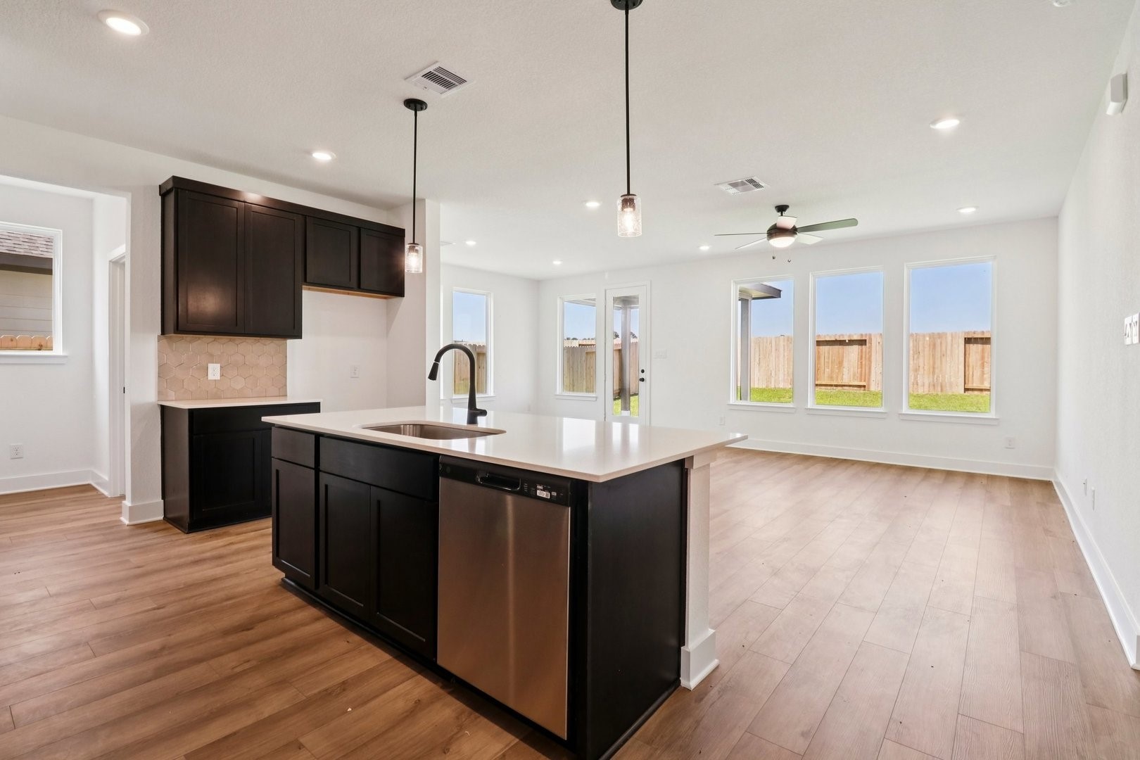 14470 Trumpet Lane Splendora, TX 77372 - Photo 6 of 27 a kitchen with a sink and a flat screen tv