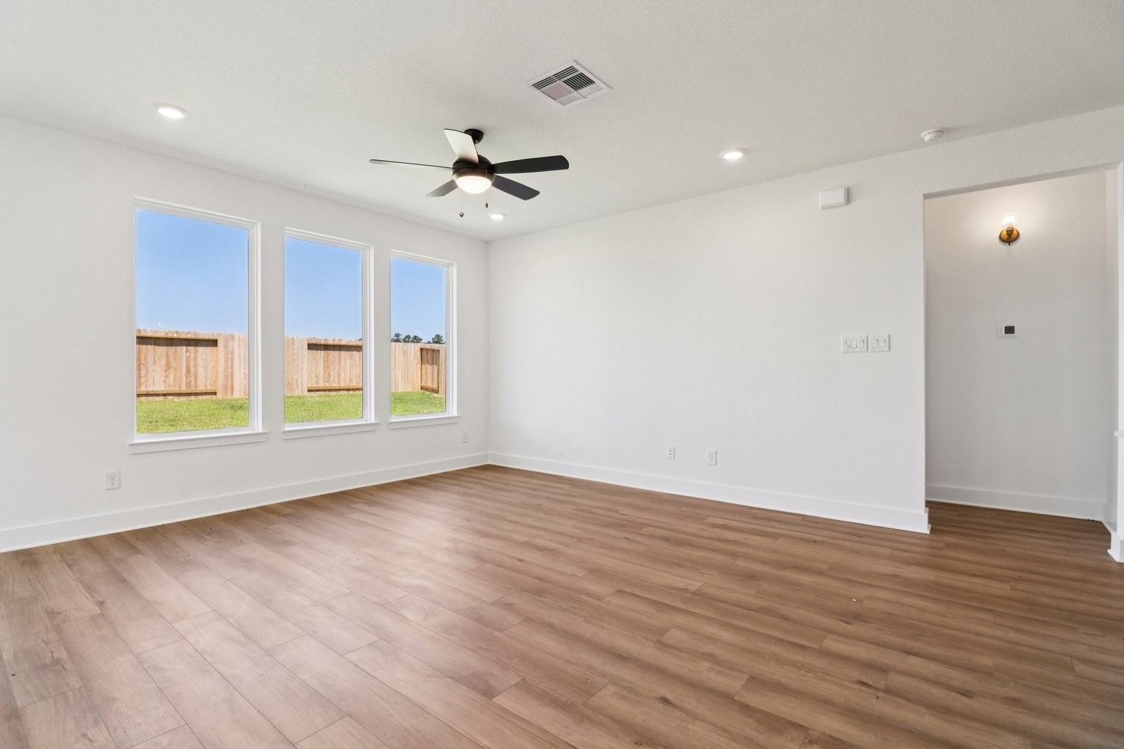 14470 Trumpet Lane Splendora, TX 77372 - Photo 8 of 27 a view of an empty room with wooden floor and a window