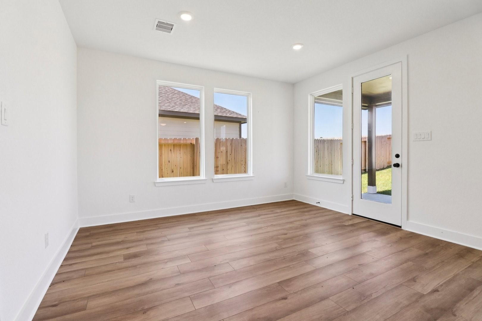 14470 Trumpet Lane Splendora, TX 77372 - Photo 9 of 27 an empty room with wooden floor and windows