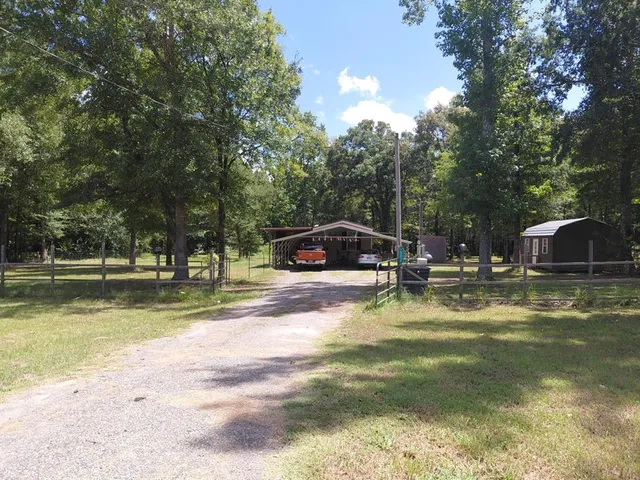 a view of yard with swimming pool and trees