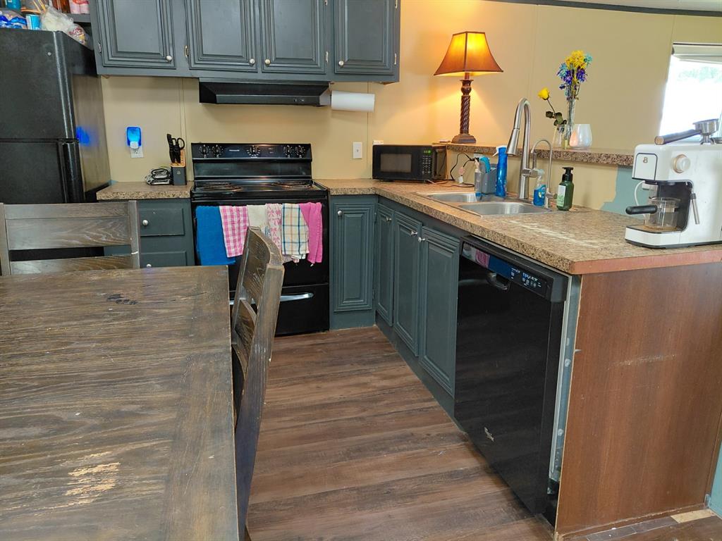 10855 Winrock Road Mooringsport, LA 71060 - Photo 12 of 21 a kitchen with stainless steel appliances granite countertop a sink stove and refrigerator