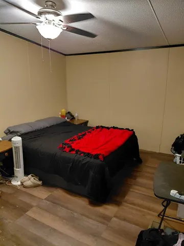 a bedroom with a bed and a chandelier