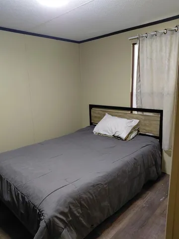 a bedroom with a bed and a table in it