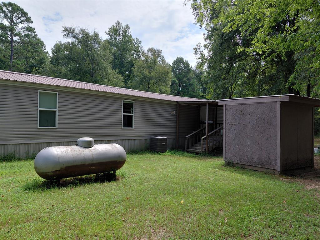 10855 Winrock Road Mooringsport, LA 71060 - Photo 18 of 21 a view of a backyard with plants and a tub