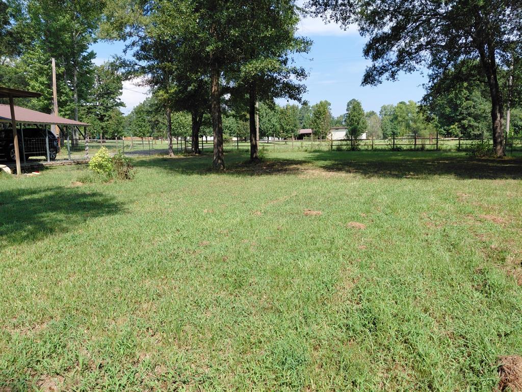 10855 Winrock Road Mooringsport, LA 71060 - Photo 7 of 21 a view of outdoor space with garden and trees